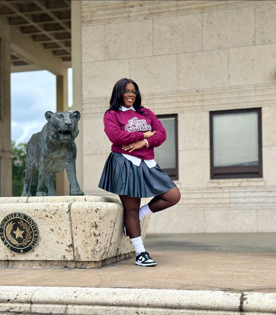 Student posing in front of the building