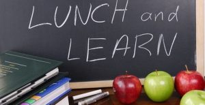 Lunch and Learn written on board with apples in-front of it